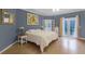 Primary bedroom with hardwood floors and access to balcony at 8407 River Branch Pl, Sanford, FL 32771