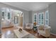 Comfortable living room with bay windows and two plush armchairs at 8407 River Branch Pl, Sanford, FL 32771