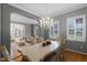 Bright dining room with a crystal chandelier and seating for six at 8407 River Branch Pl, Sanford, FL 32771
