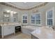 Spacious Primary bathroom with soaking tub, double vanity, and large windows at 8407 River Branch Pl, Sanford, FL 32771