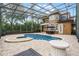 Expansive pool and spa with screened enclosure, patio furniture, and house view at 8407 River Branch Pl, Sanford, FL 32771