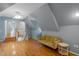 Spacious bonus room with hardwood floors, built-in shelving, and a comfortable couch at 8407 River Branch Pl, Sanford, FL 32771
