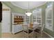 Charming breakfast nook with white cabinets and wood table at 8407 River Branch Pl, Sanford, FL 32771