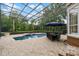 Screened pool and spa with patio furniture and a view of the house at 8407 River Branch Pl, Sanford, FL 32771