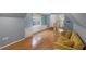 Bright bonus room with hardwood floors, built-in shelving, and a comfortable couch at 8407 River Branch Pl, Sanford, FL 32771