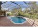 Relaxing pool and spa with screened enclosure, outdoor kitchen, and brick pavers at 8681 Crested Eagle Pl, Sanford, FL 32771