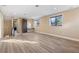 Spacious bonus room with wood-look floors and large windows at 8681 Crested Eagle Pl, Sanford, FL 32771