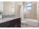 Bathroom with granite countertop, dark brown vanity, and a shower/tub combo at 8681 Crested Eagle Pl, Sanford, FL 32771