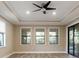 Spacious living room featuring hardwood floors and three large windows at 8681 Crested Eagle Pl, Sanford, FL 32771