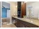Double vanity bathroom with granite countertop and dark wood cabinets at 8681 Crested Eagle Pl, Sanford, FL 32771