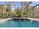 Relaxing screened pool with waterfall feature at 8681 Crested Eagle Pl, Sanford, FL 32771