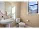 Well-lit bathroom with pedestal sink, toilet, and oval mirror at 8681 Crested Eagle Pl, Sanford, FL 32771