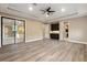 Large main bedroom with wood-look floors and access to the bathroom and backyard at 8681 Crested Eagle Pl, Sanford, FL 32771