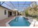 Resort-style pool with screened enclosure, brick pavers, and adjacent patio at 8681 Crested Eagle Pl, Sanford, FL 32771