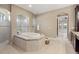 Spa-like bathroom with soaking tub, walk-in shower and large mirror at 8681 Crested Eagle Pl, Sanford, FL 32771