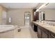 Elegant bathroom with double vanity, soaking tub and walk-in shower at 8681 Crested Eagle Pl, Sanford, FL 32771
