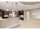 Modern kitchen with dark wood cabinets, granite countertops and island at 8681 Crested Eagle Pl, Sanford, FL 32771