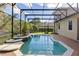 Inviting pool area with screened enclosure, brick pavers, and water feature at 8681 Crested Eagle Pl, Sanford, FL 32771