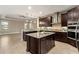 Open concept kitchen with island, stainless steel appliances, and breakfast bar at 8681 Crested Eagle Pl, Sanford, FL 32771