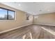 Large bonus room with wood-look floors and multiple windows at 8681 Crested Eagle Pl, Sanford, FL 32771