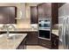 Modern kitchen with stainless steel appliances and dark wood cabinets at 8681 Crested Eagle Pl, Sanford, FL 32771