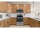 Modern kitchen with stainless steel appliances and light wood cabinets at 10274 Hadley St, Orlando, FL 32829