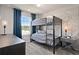 Charming bedroom with bunk beds, window, and world map wall decor at 10274 Hadley St, Orlando, FL 32829
