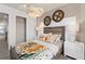 Spacious bedroom with a queen bed, walk-in closet, and unique wall decor at 10274 Hadley St, Orlando, FL 32829