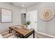 Light-filled home office with a desk and large wall art at 10274 Hadley St, Orlando, FL 32829