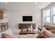 Bright living room features a comfy sofa and large TV, perfect for relaxation at 10274 Hadley St, Orlando, FL 32829