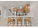 Kitchen features a breakfast bar with three stools and modern pendant lighting at 10274 Hadley St, Orlando, FL 32829