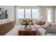 Light-filled living room with comfortable seating and large windows at 10274 Hadley St, Orlando, FL 32829