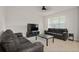 Living room with black couches and a large TV at 13330 Abuela Aly, Windermere, FL 34786