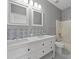 Elegant bathroom with double vanity and patterned tile at 17515 Blessing Dr, Clermont, FL 34714