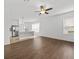 Open living room with kitchen island and wood floors at 17515 Blessing Dr, Clermont, FL 34714