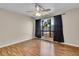 Bedroom with wood floors, large window with black curtains, and ceiling fan at 1836 N Crystal Lake Dr # 31, Lakeland, FL 33801