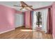 Bright bedroom with wood floors, ceiling fan, and ample closet space at 1836 N Crystal Lake Dr # 31, Lakeland, FL 33801