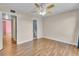 Bedroom with wood floors, access to bathroom, and ceiling fan at 1836 N Crystal Lake Dr # 31, Lakeland, FL 33801