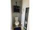 Small bathroom with toilet and floating shelf at 2030 Cascades Blvd # 302, Kissimmee, FL 34741