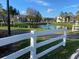 Peaceful pond with fountain and white fence at 2030 Cascades Blvd # 302, Kissimmee, FL 34741