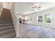 Open living room and kitchen with gray vinyl flooring and ceiling fan at 2076 Cades Cove Way, Deland, FL 32720
