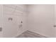 Bright laundry room with wire shelving and vinyl flooring at 2076 Cades Cove Way, Deland, FL 32720