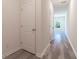 Bright hallway with light gray vinyl flooring and white doors at 2076 Cades Cove Way, Deland, FL 32720
