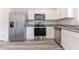 Modern kitchen with stainless steel appliances and granite countertops at 2076 Cades Cove Way, Deland, FL 32720