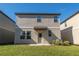 Two-story townhome with a small grassy backyard at 2076 Cades Cove Way, Deland, FL 32720