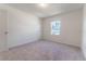 Simple bedroom with carpeted floor and window at 2076 Cades Cove Way, Deland, FL 32720