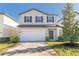 Two-story house with a white garage door and landscaping at 2076 Cades Cove Way, Deland, FL 32720