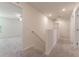 Upstairs hallway with neutral carpeting and access to bedrooms at 2076 Cades Cove Way, Deland, FL 32720