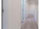 Upstairs hallway with carpet and access to bedrooms at 2076 Cades Cove Way, Deland, FL 32720