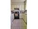 Kitchen with white cabinets, black appliances, and granite countertops at 2314 Carriage Run Rd, Kissimmee, FL 34741